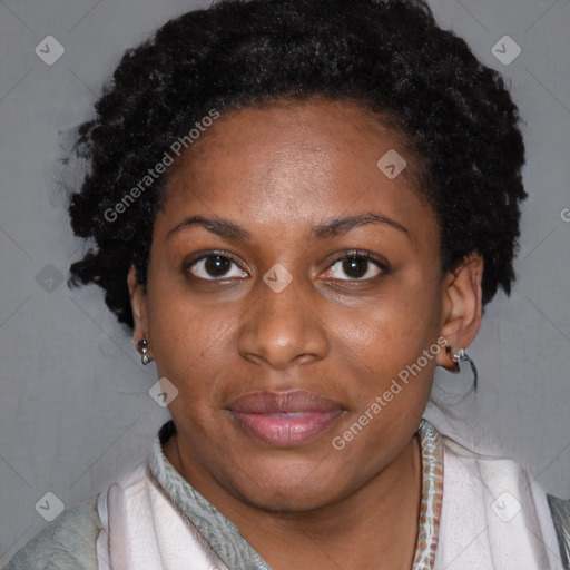 Joyful black adult female with short  brown hair and brown eyes