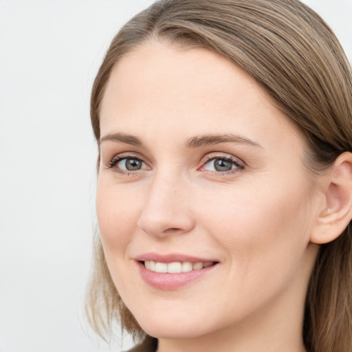 Joyful white young-adult female with long  brown hair and blue eyes