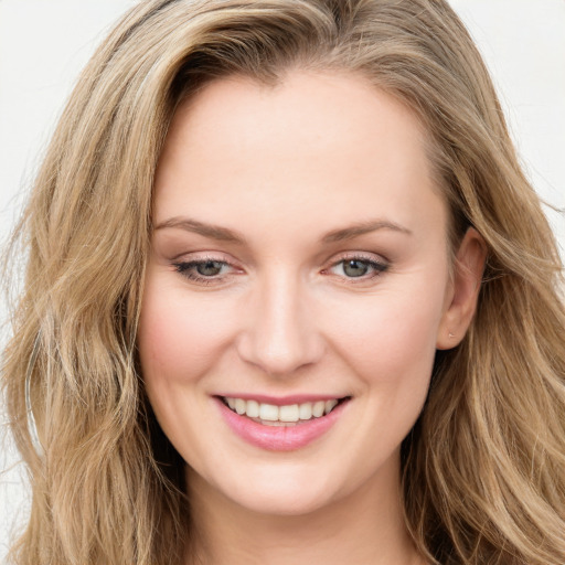 Joyful white young-adult female with long  brown hair and blue eyes