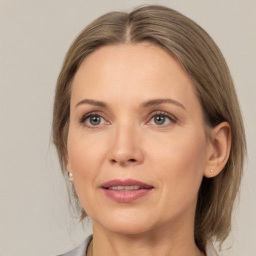 Joyful white adult female with medium  brown hair and brown eyes