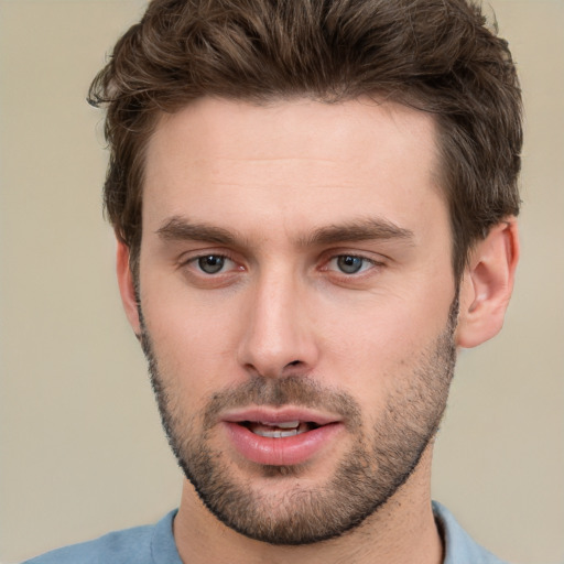 Joyful white young-adult male with short  brown hair and grey eyes