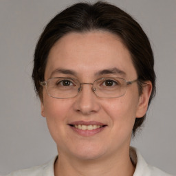 Joyful white adult female with medium  brown hair and brown eyes