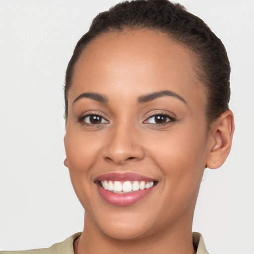 Joyful latino young-adult female with short  brown hair and brown eyes