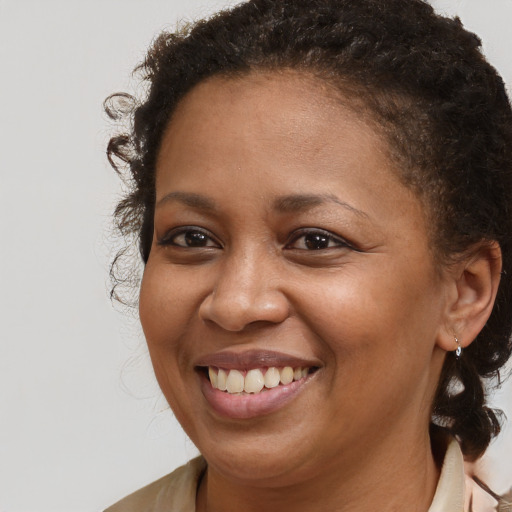Joyful black young-adult female with medium  brown hair and brown eyes