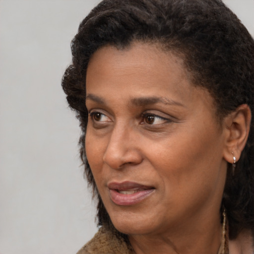 Joyful black adult female with short  brown hair and brown eyes