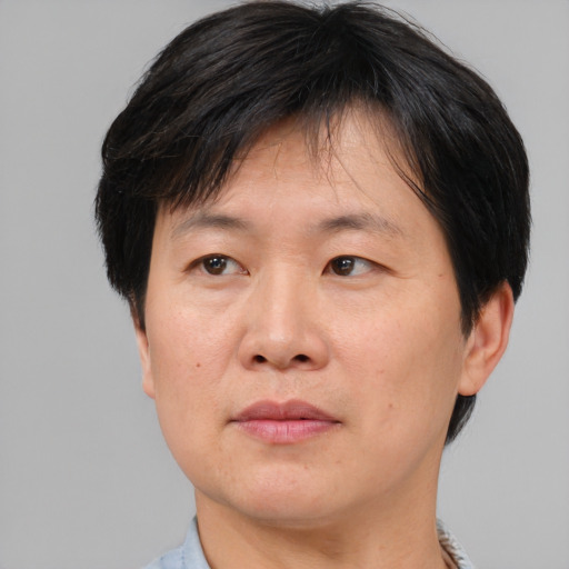 Neutral asian adult male with short  brown hair and brown eyes