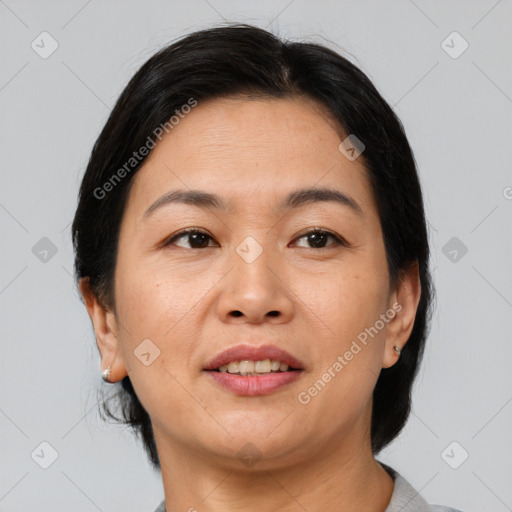 Joyful asian adult female with medium  brown hair and brown eyes