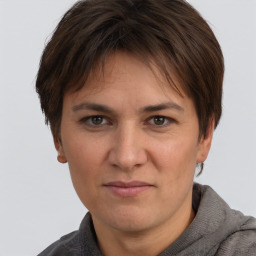 Joyful white adult female with short  brown hair and brown eyes