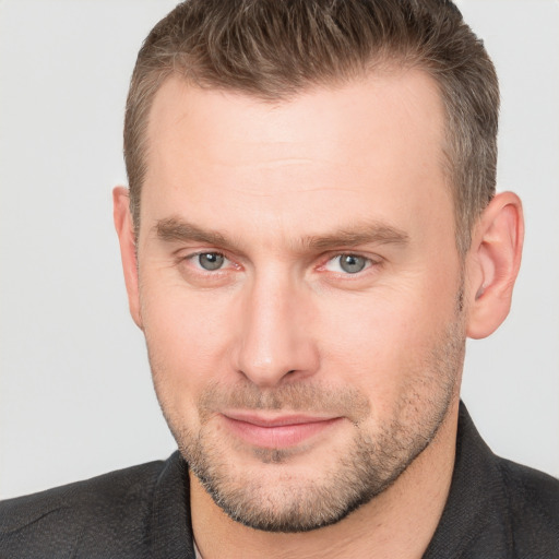 Joyful white adult male with short  brown hair and brown eyes