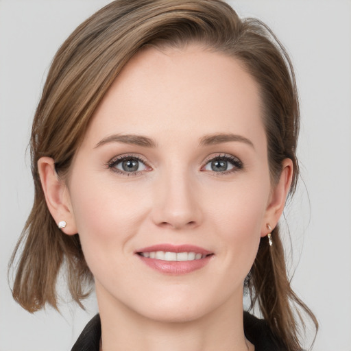 Joyful white young-adult female with medium  brown hair and grey eyes