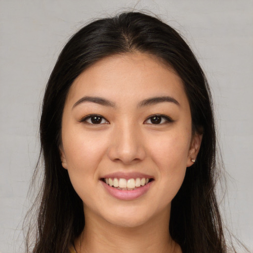 Joyful white young-adult female with long  brown hair and brown eyes