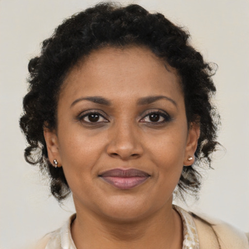 Joyful black adult female with short  brown hair and brown eyes