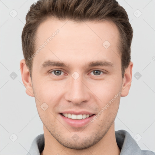 Joyful white young-adult male with short  brown hair and grey eyes