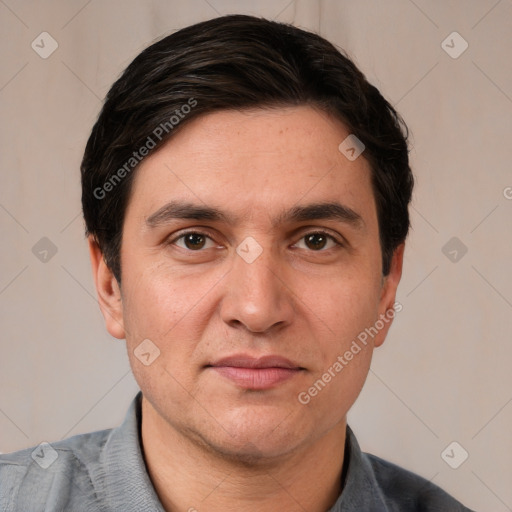 Joyful white adult male with short  black hair and brown eyes