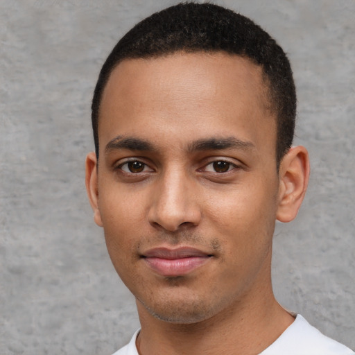 Joyful white young-adult male with short  black hair and brown eyes