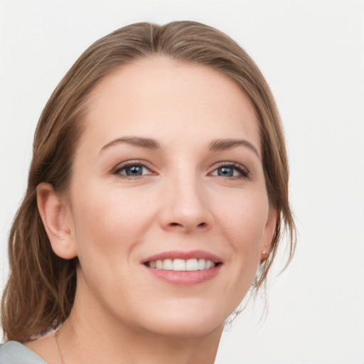 Joyful white young-adult female with medium  brown hair and grey eyes