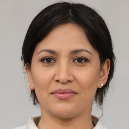 Joyful white adult female with medium  brown hair and brown eyes