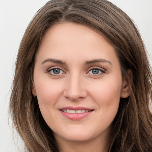 Joyful white young-adult female with long  brown hair and grey eyes