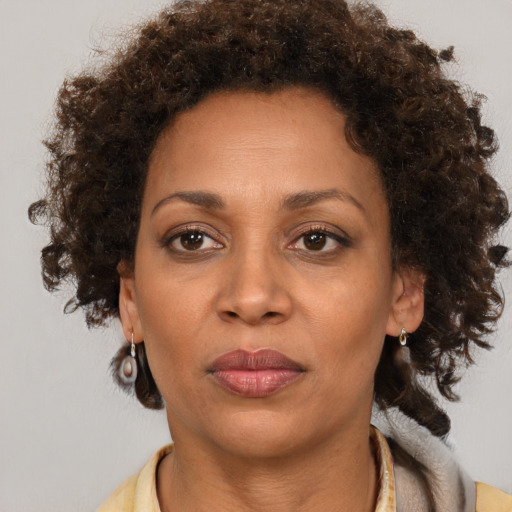Joyful black adult female with short  brown hair and brown eyes
