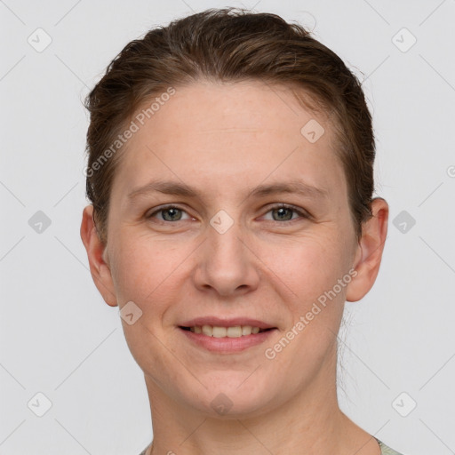 Joyful white young-adult female with short  brown hair and grey eyes