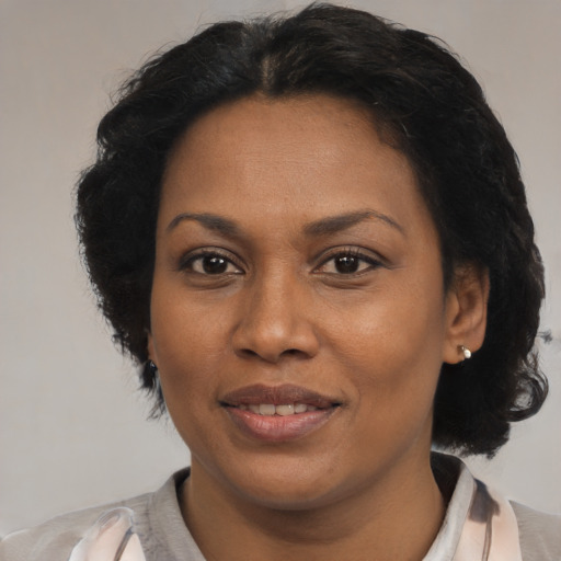 Joyful latino adult female with short  black hair and brown eyes