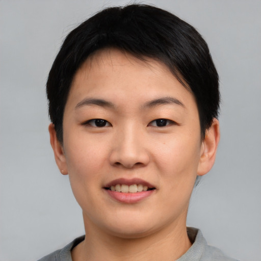 Joyful asian young-adult female with short  black hair and brown eyes