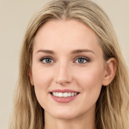 Joyful white young-adult female with long  brown hair and green eyes