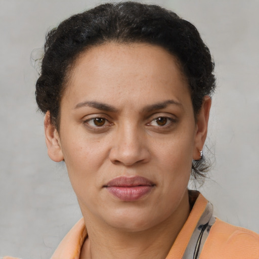 Joyful latino adult female with short  brown hair and brown eyes