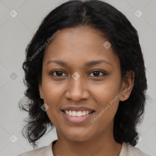 Joyful black young-adult female with long  brown hair and brown eyes