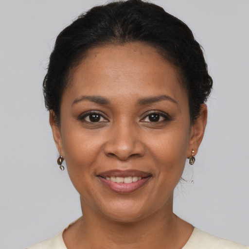 Joyful latino young-adult female with short  brown hair and brown eyes