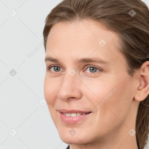 Joyful white young-adult female with medium  brown hair and grey eyes