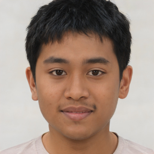 Joyful asian young-adult male with short  brown hair and brown eyes