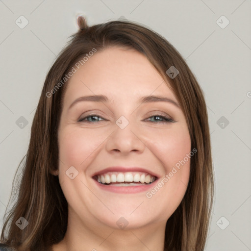 Joyful white young-adult female with long  brown hair and grey eyes