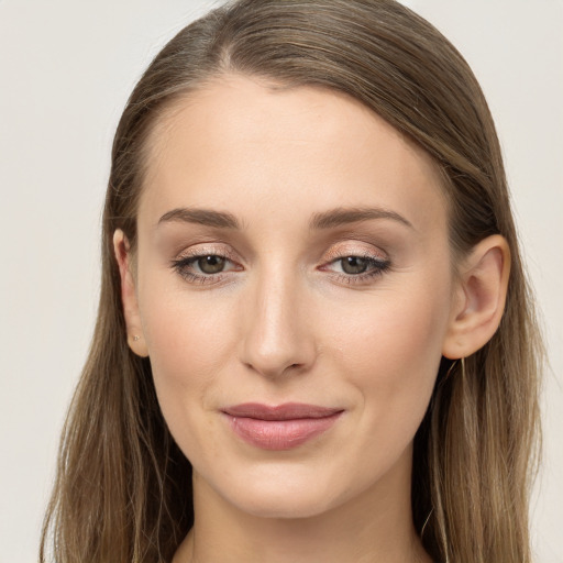 Joyful white young-adult female with long  brown hair and grey eyes