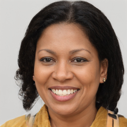 Joyful latino adult female with medium  brown hair and brown eyes