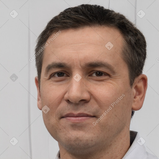 Joyful white adult male with short  brown hair and brown eyes