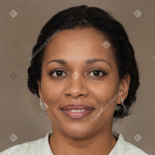 Joyful black adult female with short  brown hair and brown eyes