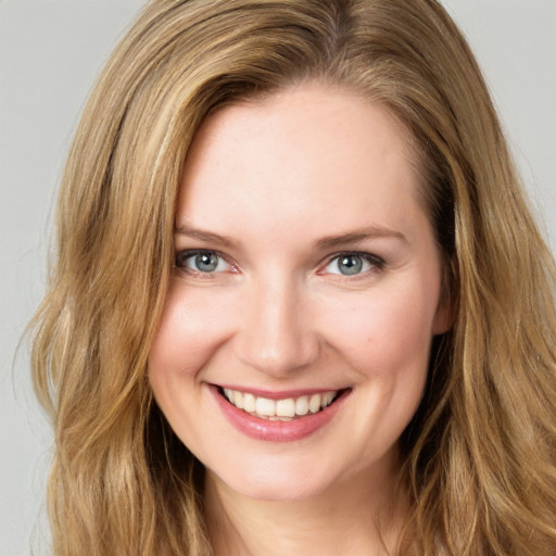 Joyful white young-adult female with long  brown hair and green eyes