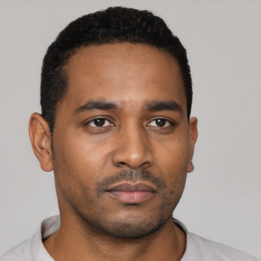 Neutral black young-adult male with short  black hair and brown eyes