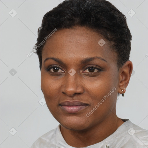 Joyful black young-adult female with short  black hair and brown eyes