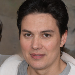 Joyful white adult male with medium  brown hair and brown eyes