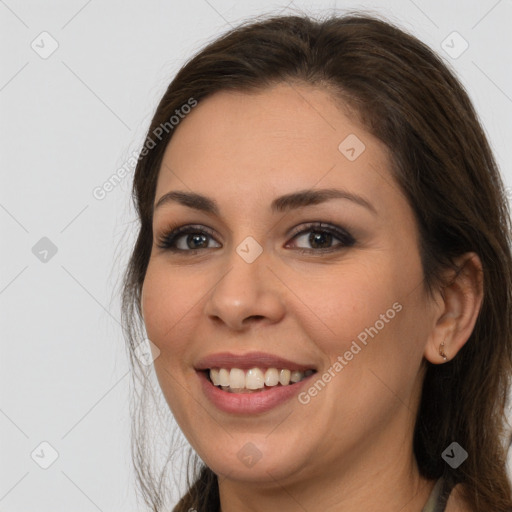 Joyful white young-adult female with long  brown hair and brown eyes