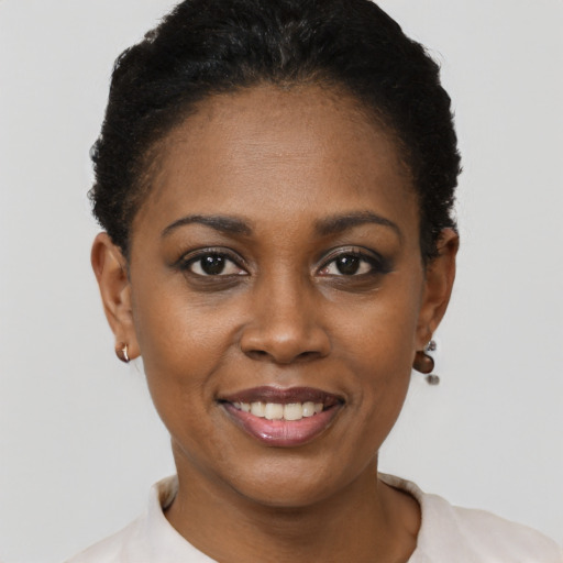 Joyful black young-adult female with short  brown hair and brown eyes