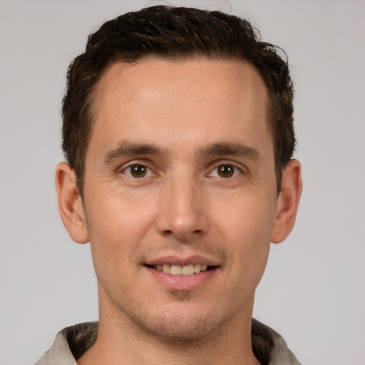 Joyful white young-adult male with short  brown hair and brown eyes