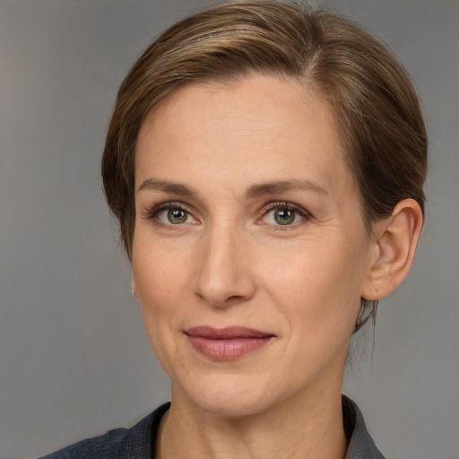 Joyful white adult female with medium  brown hair and grey eyes