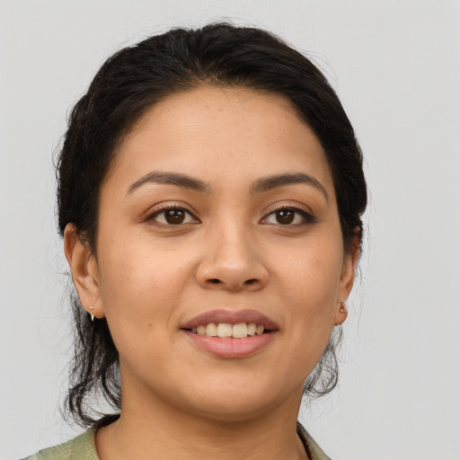 Joyful latino young-adult female with medium  brown hair and brown eyes