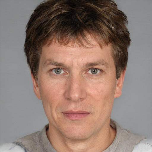 Neutral white adult male with short  brown hair and grey eyes