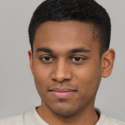 Joyful latino young-adult male with short  brown hair and brown eyes