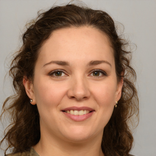 Joyful white young-adult female with medium  brown hair and green eyes