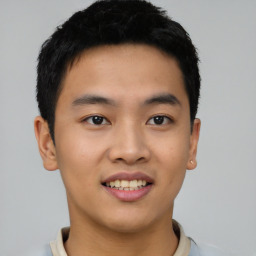 Joyful asian young-adult male with short  black hair and brown eyes